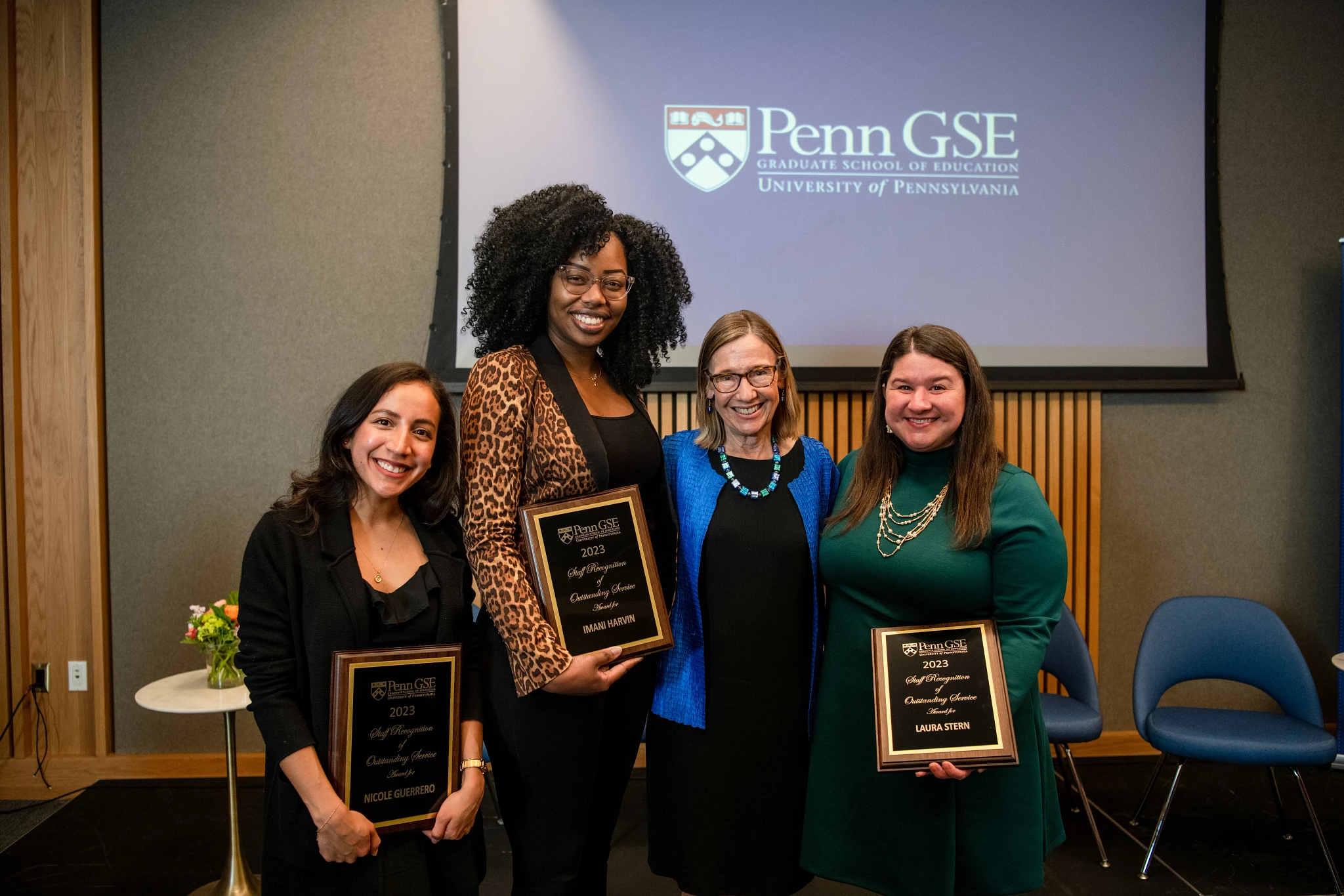 Dean Grossman poses with the three smiling Penn GSE staffers who are holding their awards.