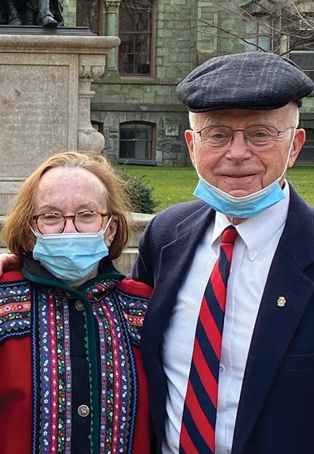 Susan Cotton and Doug Cotton are seen with masks against the backdrop of College Hall at Penn. Photo by Jane Lindahl