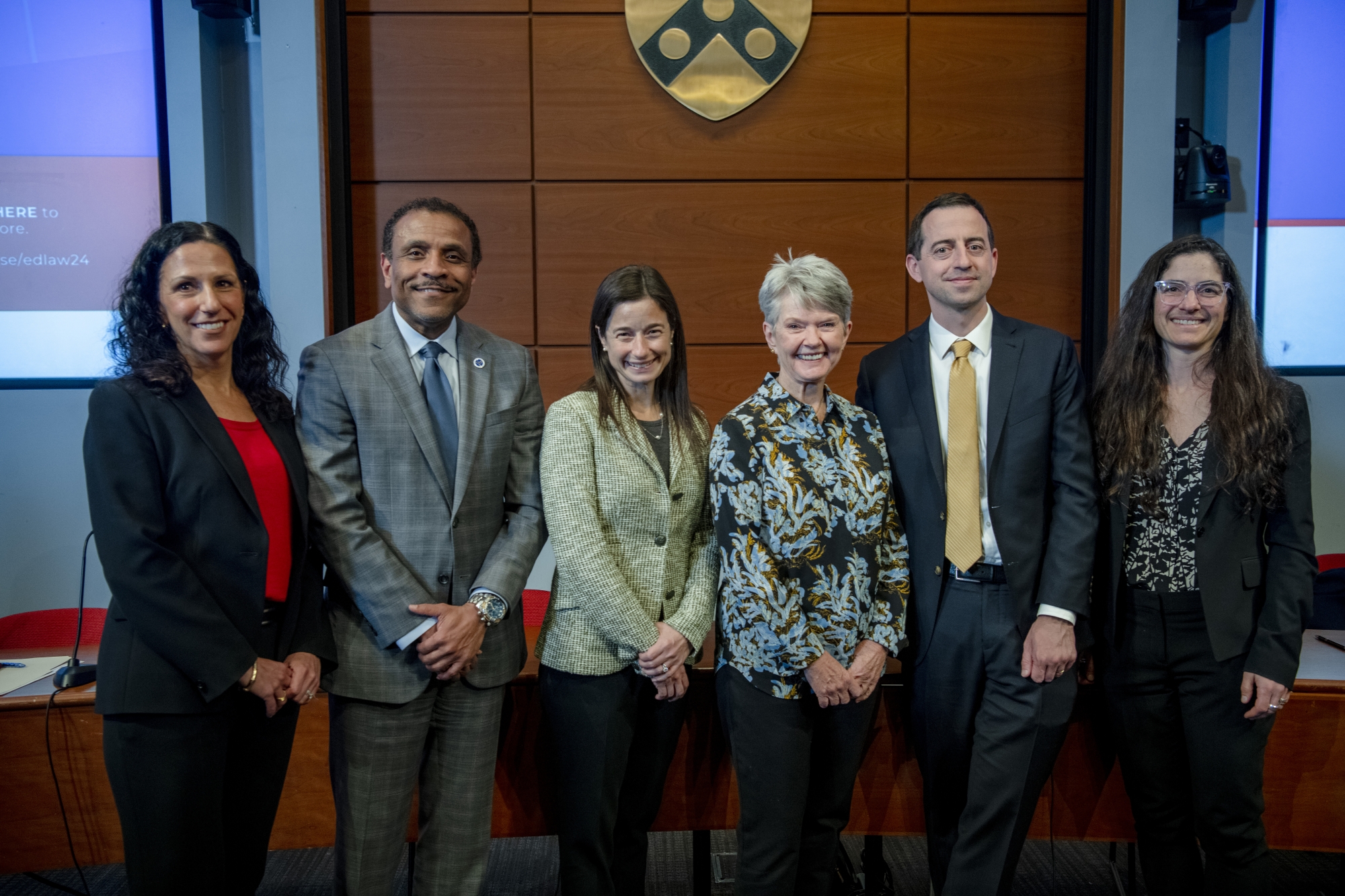 Penn GSE and Penn Carey Law deans stand posing with the panelists from the Goldberg/Christman lecture along with the lecture’s founder and namesake.
