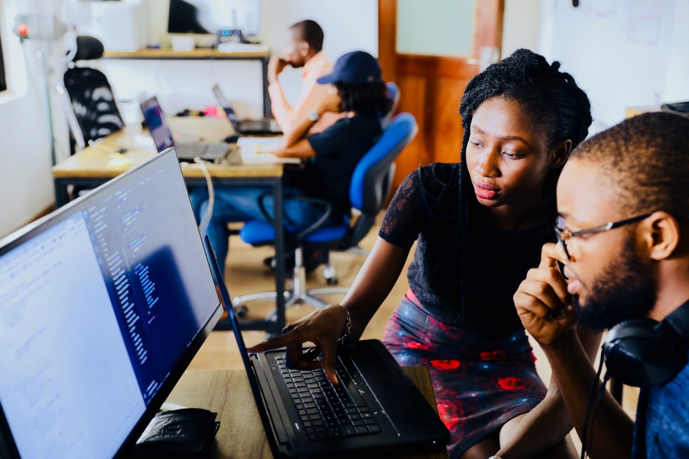 A woman and man looking at a computer screen together