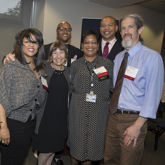 Dean Grossman standing and smiling with award nominees.