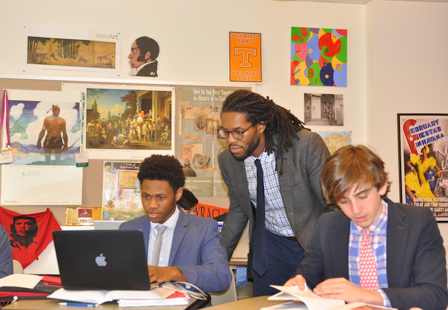 Teacher Brendon Jobs in the classroom with two high-school aged students.