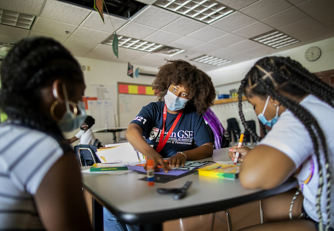 A teacher works with two students