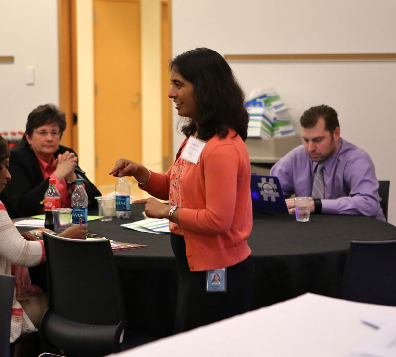 A speaker presenting to a group of educators