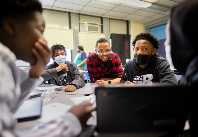 Tamir Harper smiles with his students at Henry C. Lea School