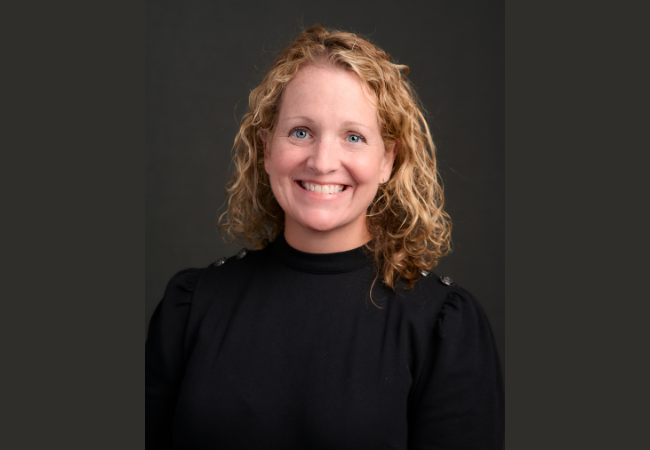 Janice Rafferty Grady  smiles at the camera wearing a black turtleneck