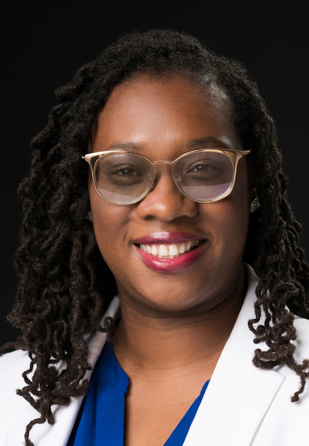 Aheadshot of Jasmine Marshall-Butler wearing glasses and smiling.