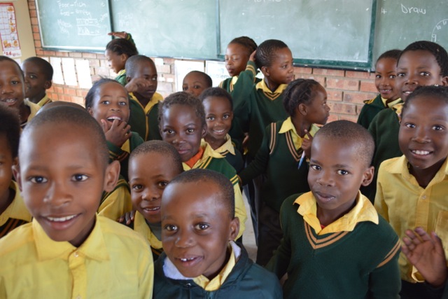 Young students pose for a photo.