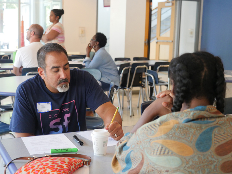 two people talking across a table