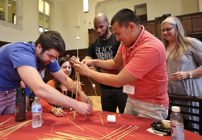 Students in a project-based learning certificate program class collaborate to find a solution to a problem. 