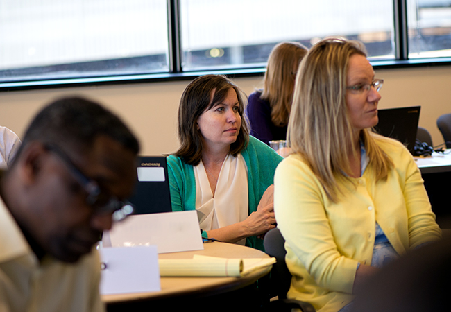 Graduate students sitting in classroom.