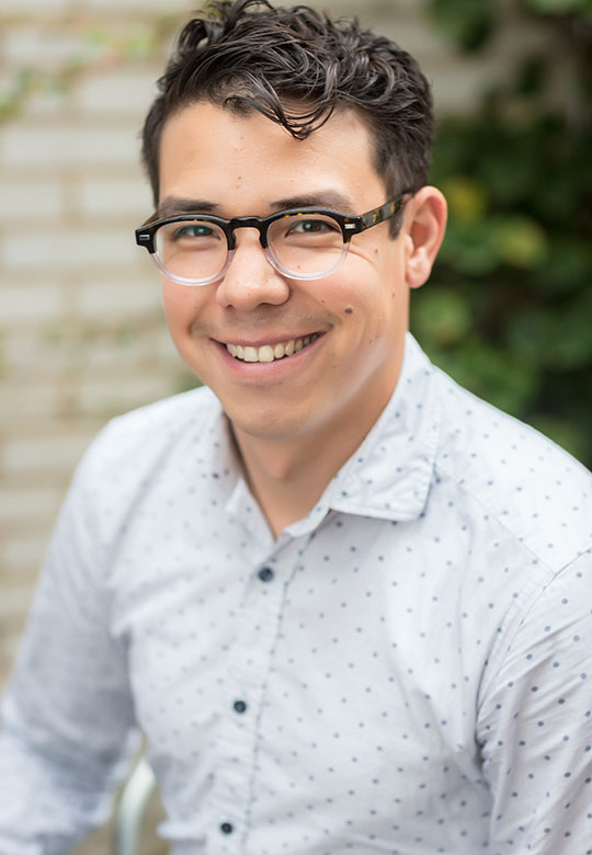 Man with white shirt and glasses.