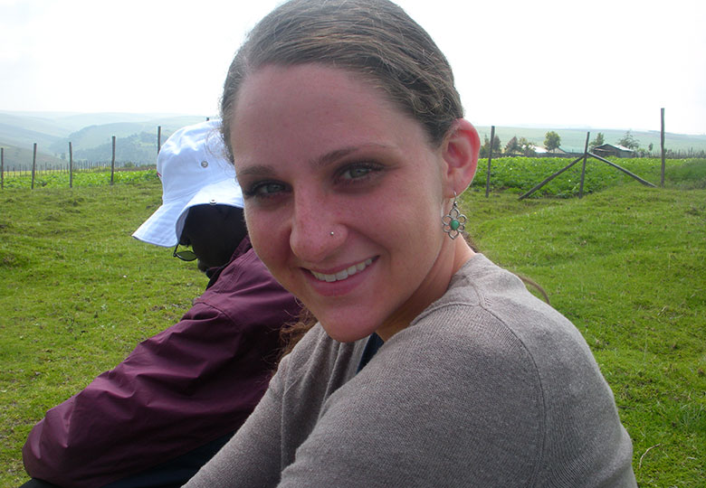 Smiling young woman sitting outside.