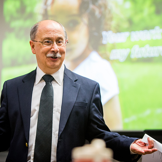Male professor with glasses standing and talking