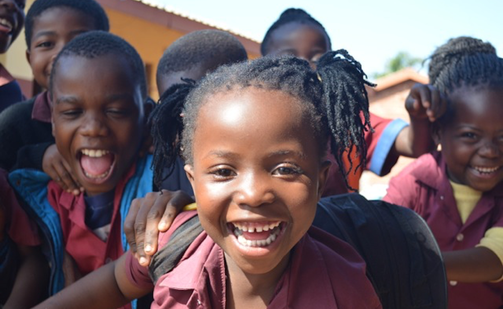 Children outside laughing in international location