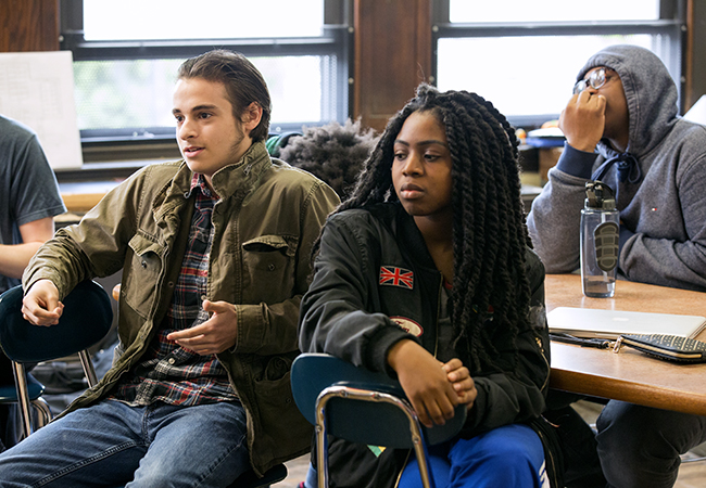 Three students sitting in a classroom