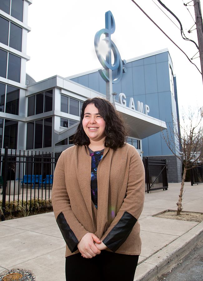 Woman standing in front of building that says GAMP in big letters.