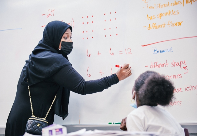 teacher in front of a math classroom