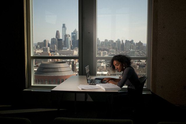 A student uses a laptop while studying.