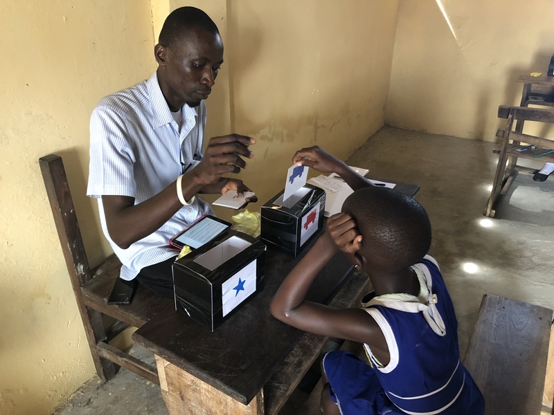 A teacher and a student perform an exercise in a classroom in Ghana as part of Sharon Wolf's teacher training program.