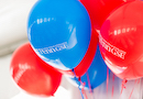Red and blue balloons with Penn GSE logo