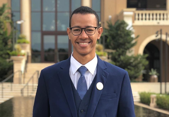 Abdulrahman Bindamnan smiling in a suit