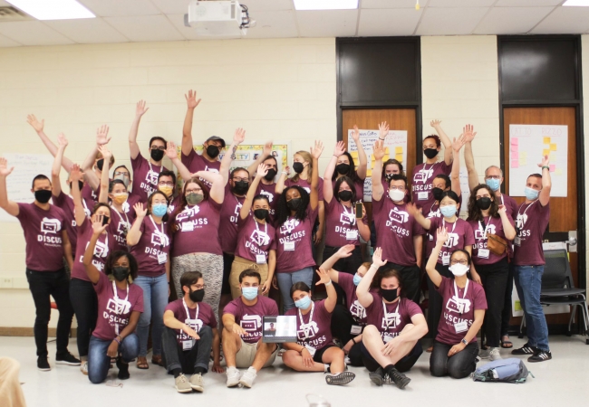 a group of social studies teachers raising their hands