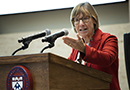 Pam Grossman speaking at a podium