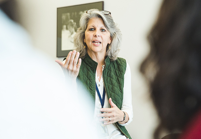 Caroline Watts speaks at a panel event about mental health in student populations.