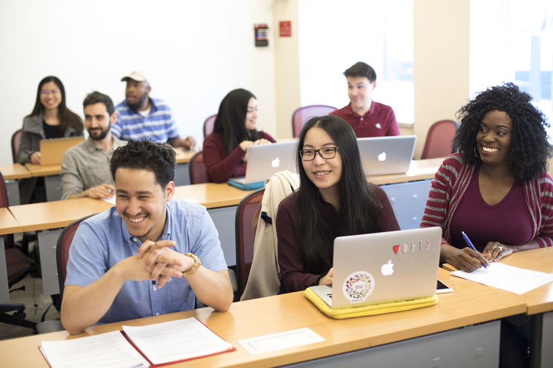 Penn GSE students smile during a class.