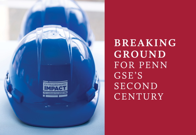 Shiny blue hardhats with the “Extraordinary Impact” logo sit on a table.