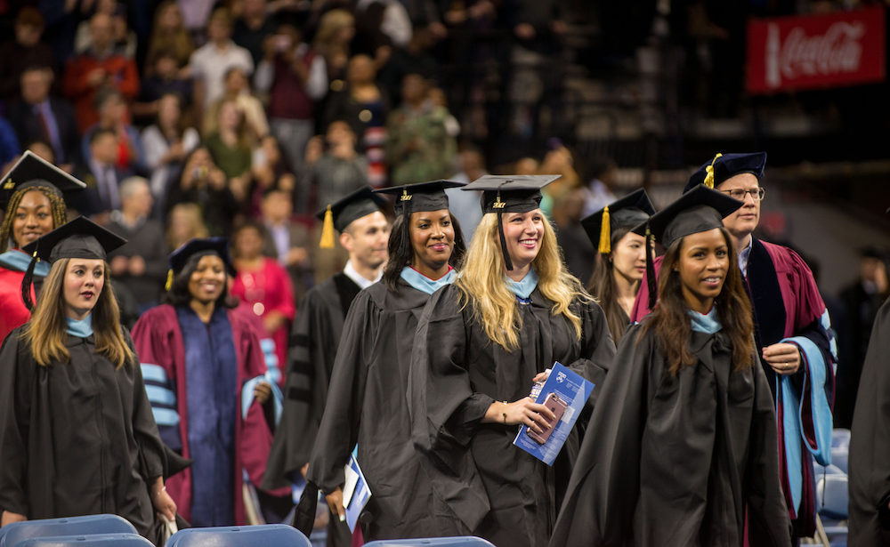 Penn GSE graduates in caps and gowns walking at Commencement