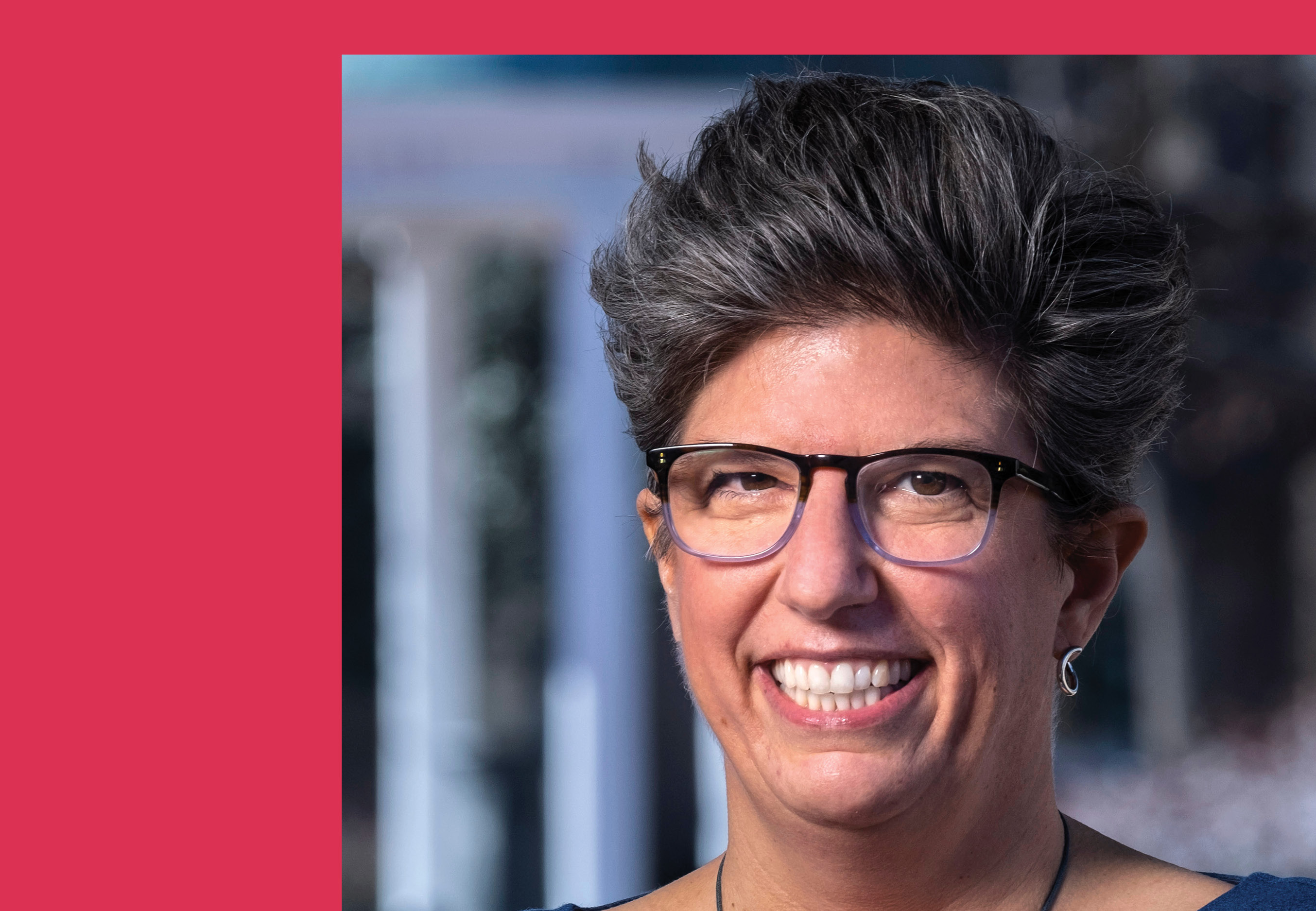 Headshot of Becci Menghini with a red frame on two sides