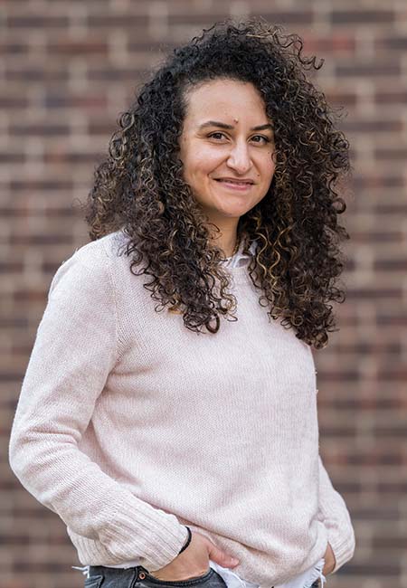 Portrait photograph of Alamia Biro against a blurred backdrop.