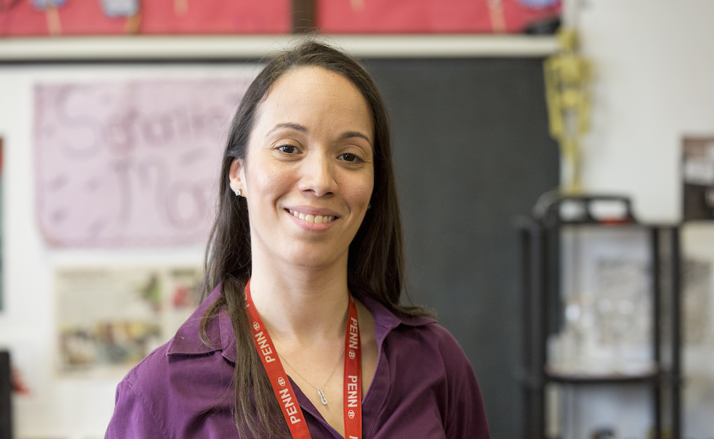 Penn GSE alumna teacher in Philadelphia classroom wearing Penn lanyard