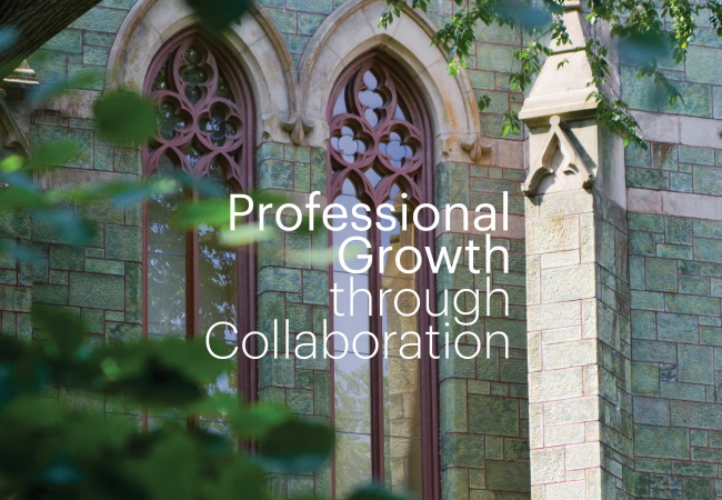 A close-up of Penn’s College Hall shows a stone wall with two vertical windows outlined in red, seen between green tree branches.