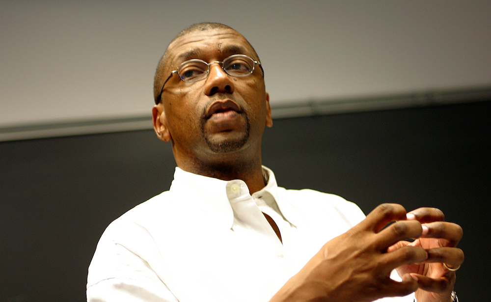 Professor speaking in front of a chalkboard