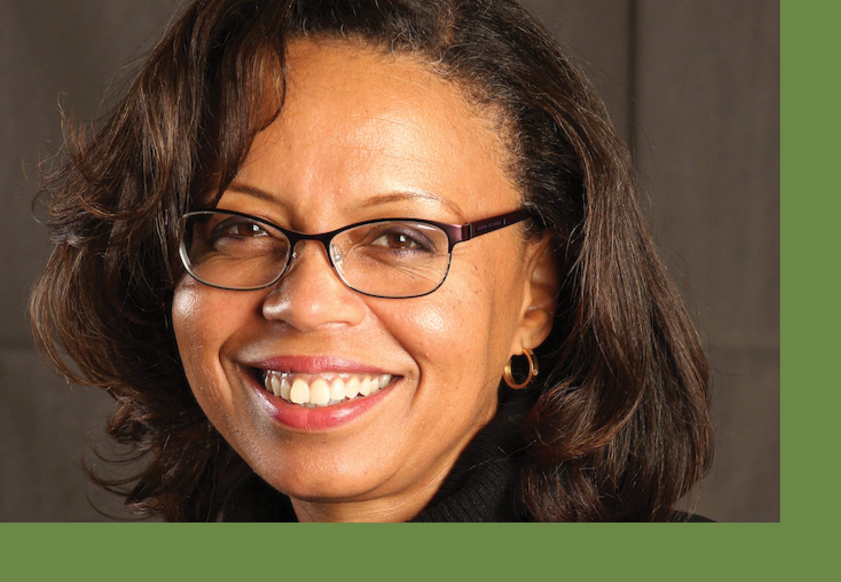 Headshot of Sonia Elliott against a deep brown backdrop.