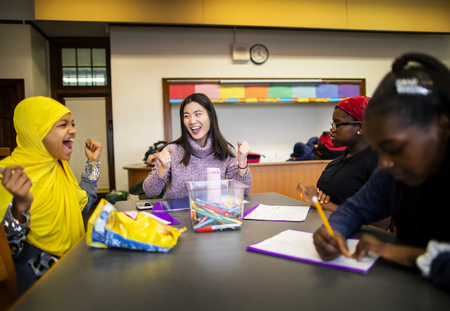 Shiyu Sun, a Penn GSE counseling student, and Philadelphia middle schooler Ciani Patton-Collins laugh together during a mentoring session. 