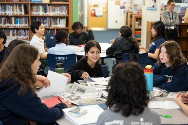 Middle school-aged children engaged in group discussion at Penn Alexander Elementary
