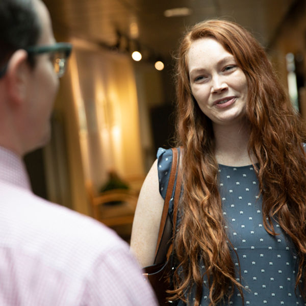 A students greets a professor outside of class.