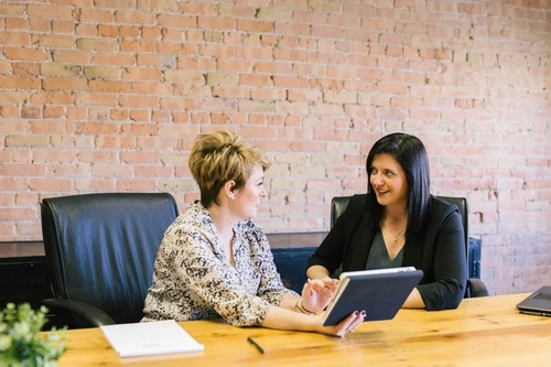 Two professional women talking to each other