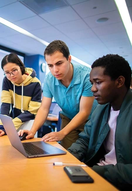 Students looking at a laptop