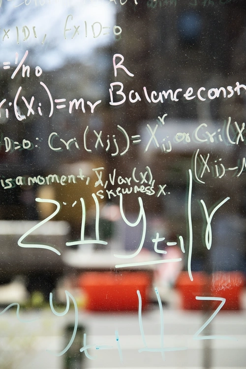 mathematical equations written on glass