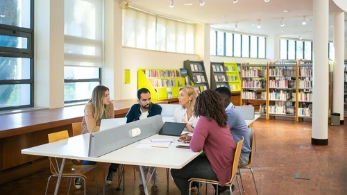 Teachers sitting around a conference table learning