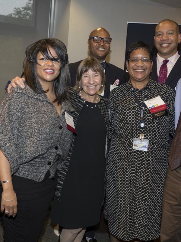 Dean Grossman standing and smiling with award nominees.