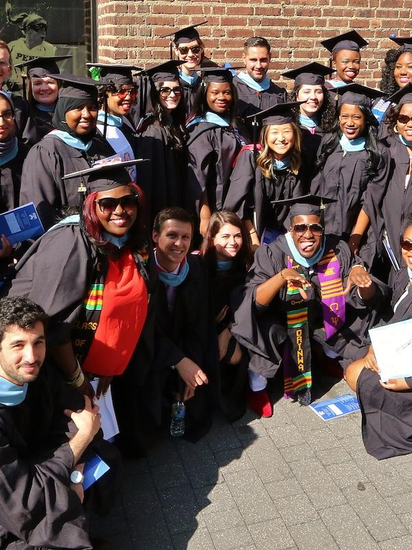Large group of Penn GSE graduates pose for a picture outside.