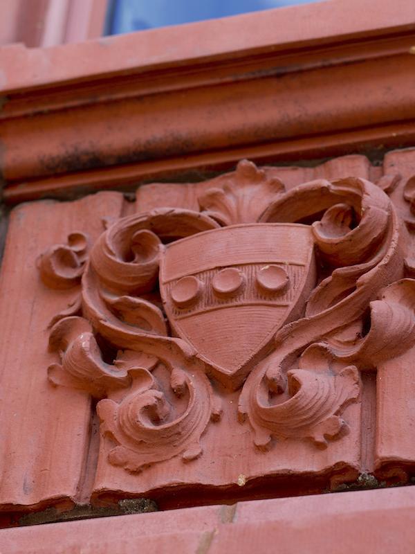 Mold of the Penn Crest on the side of a building