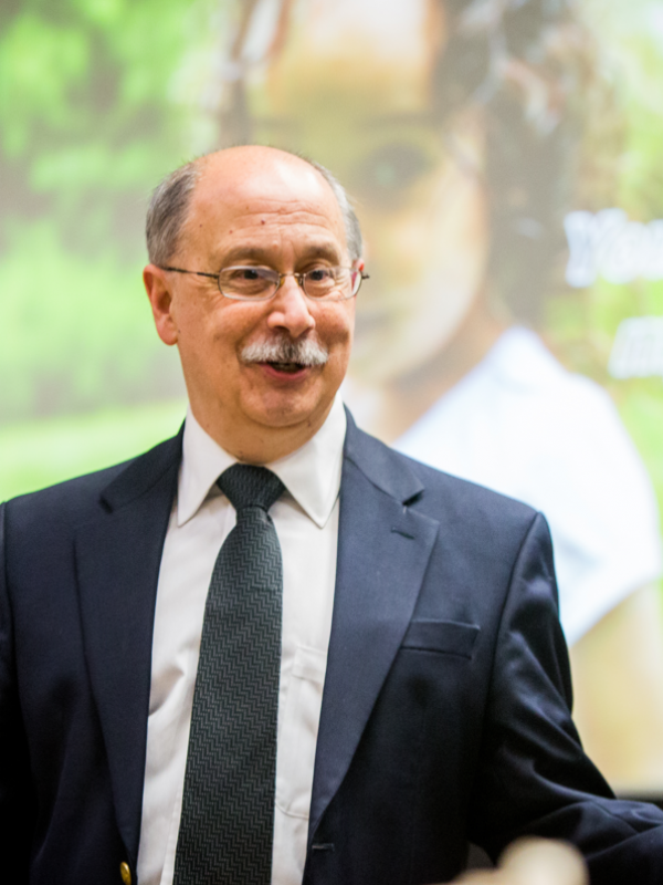 Male professor with glasses standing and talking