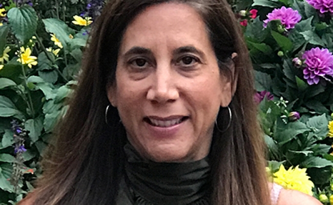 Woman smiling with background of flowers